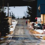 A person walking down a snow covered road