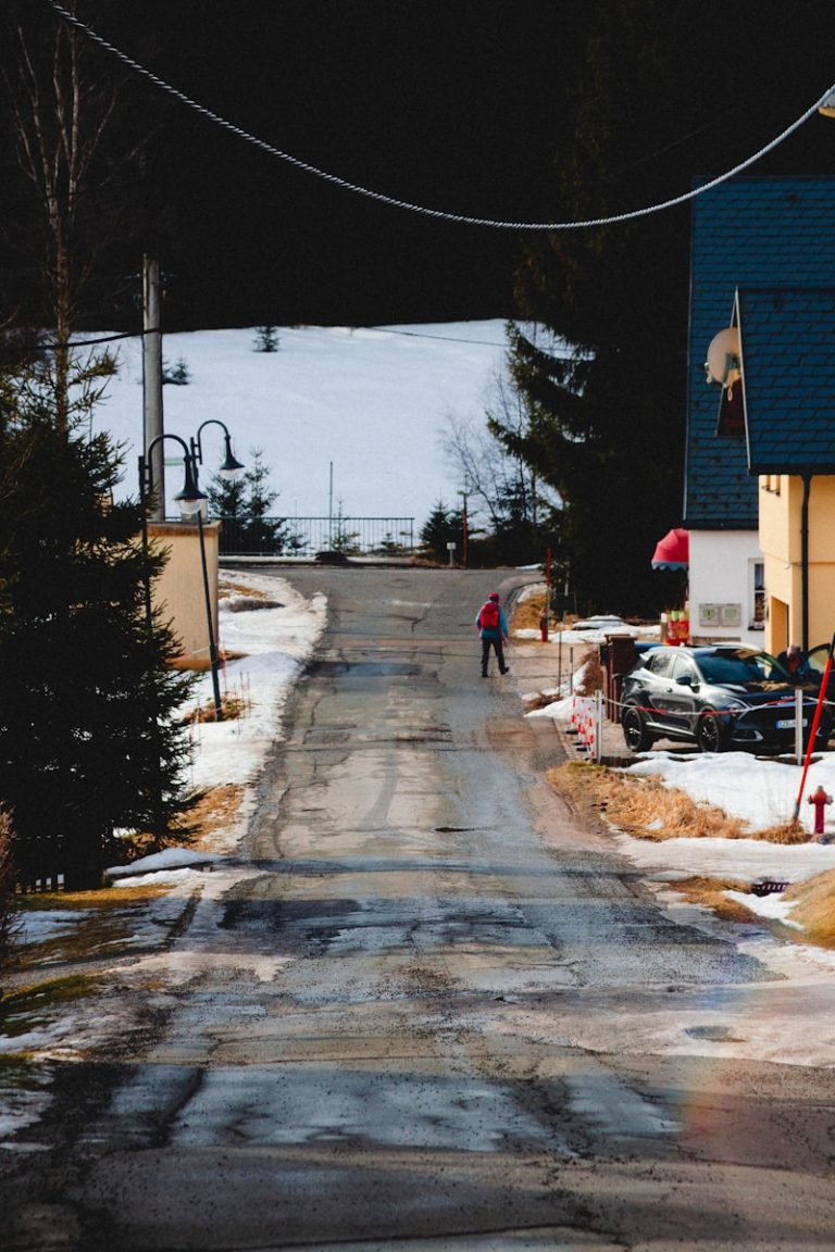 A person walking down a snow covered road