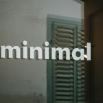 a close up of a glass door with the word minimal on it