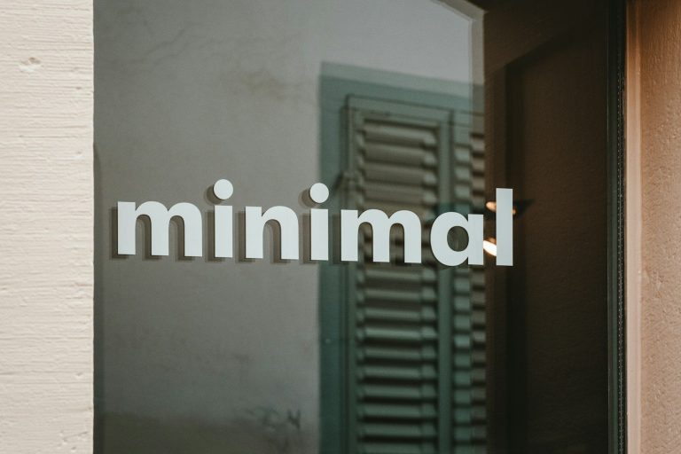 a close up of a glass door with the word minimal on it