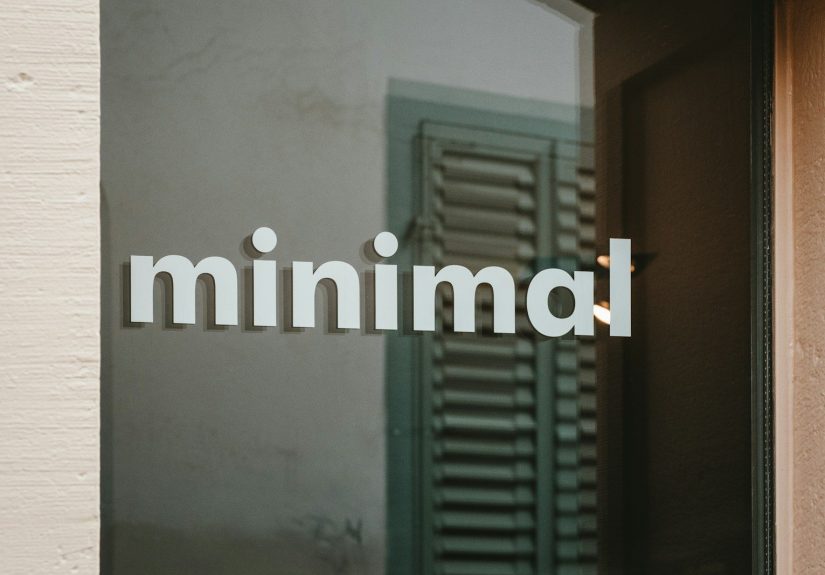 a close up of a glass door with the word minimal on it