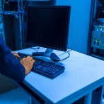 an-it-professional-operates-a-computer-in-a-server-room-managing-network-systems[1]
