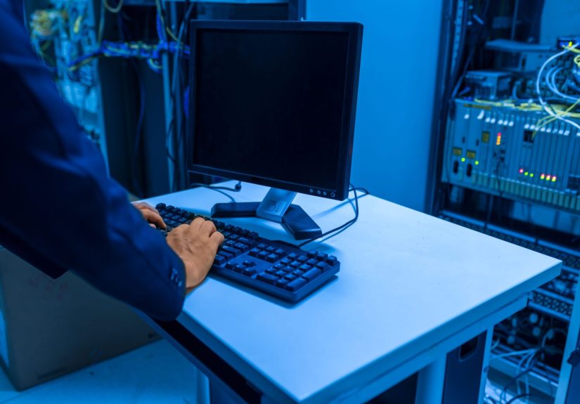 an-it-professional-operates-a-computer-in-a-server-room-managing-network-systems[1]